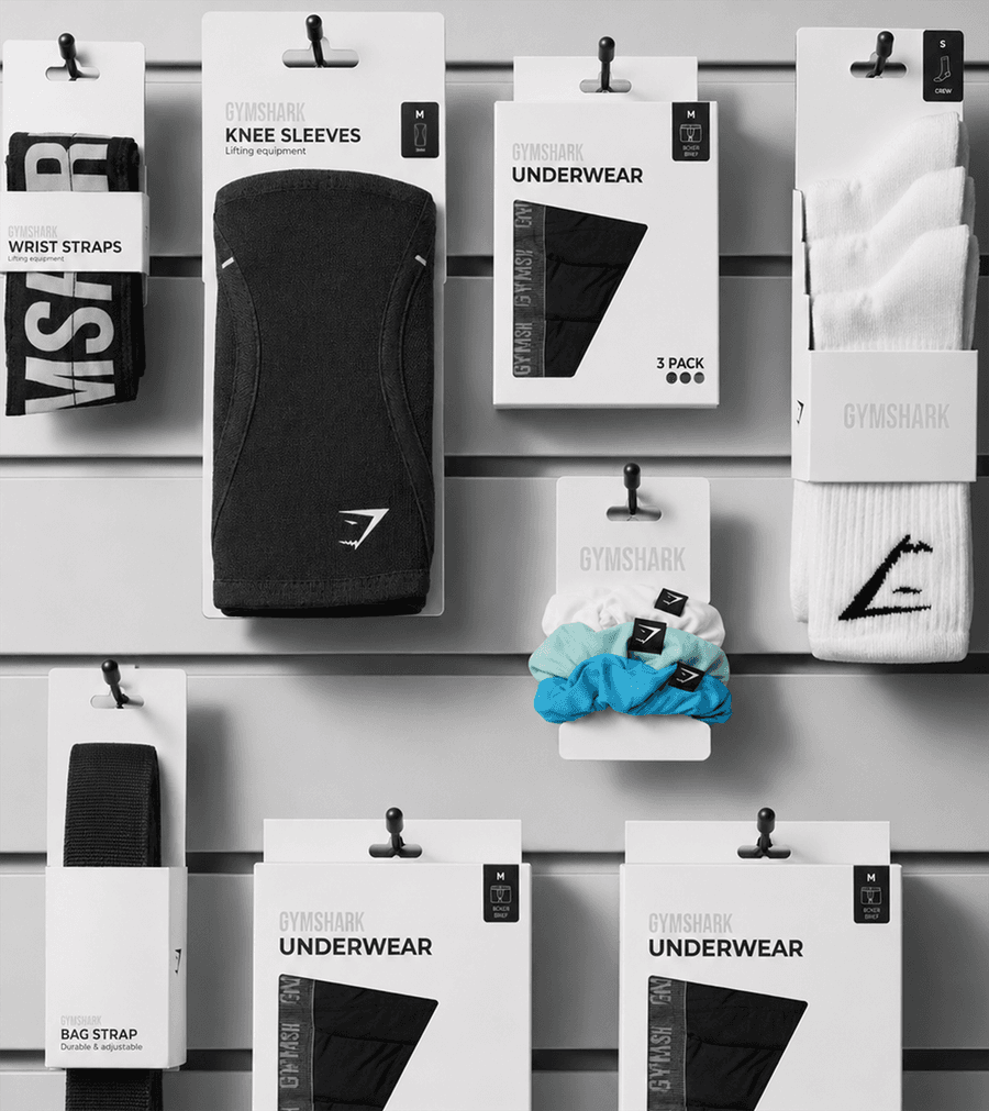 Gymshark accessory packaging displayed on a retail store wall